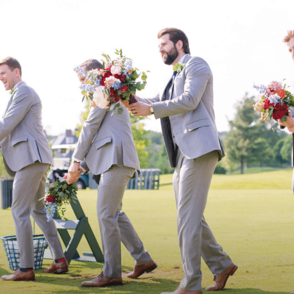 wedding photo of groomsmen golfing with flowers at New Albany Country Club